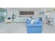 Open-concept living room with light wood floors, comfortable seating, and easy access to the kitchen and exercise room at 13307 Alderley Dr, Orlando, FL 32832
