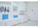Bright mudroom featuring custom built-ins, seating, and storage, with a window allowing natural light to illuminate the space at 13307 Alderley Dr, Orlando, FL 32832