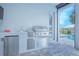 Outdoor kitchen featuring a stainless steel grill, sink, refrigerator, and storage drawers at 13307 Alderley Dr, Orlando, FL 32832