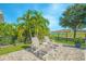 Relaxing patio seating with comfortable chairs and ottomans, surrounded by lush greenery and scenic views at 13307 Alderley Dr, Orlando, FL 32832