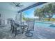 Outdoor patio with dining area and built-in outdoor kitchen overlooking a pool, perfect for entertaining and relaxation at 13307 Alderley Dr, Orlando, FL 32832
