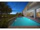 Gorgeous pool with spillover and patio, with a covered area with outdoor dining at 13307 Alderley Dr, Orlando, FL 32832