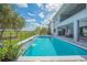 Lush backyard with pool, spa, and patio area offering stunning views of the golf course and surrounding landscape at 13307 Alderley Dr, Orlando, FL 32832