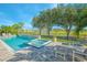 Backyard oasis with a pool, spa, patio seating, and beautiful views of the golf course and surrounding nature at 13307 Alderley Dr, Orlando, FL 32832