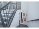 Elegant staircase with wrought iron railing and dark wood steps leading to the home's entrance and upper levels at 13307 Alderley Dr, Orlando, FL 32832