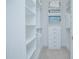 Organized walk-in closet featuring built-in shelving and drawers, maximizing storage space with a clean, white finish at 13307 Alderley Dr, Orlando, FL 32832