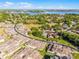 Aerial view of a neighborhood near a lake and surrounded by trees at 13326 Fountainbleau Dr, Clermont, FL 34711
