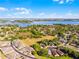 Aerial view of a neighborhood near a lake and surrounded by trees at 13326 Fountainbleau Dr, Clermont, FL 34711