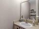 Powder room features a stylish sink, decorative mirror and charming wall decor at 13326 Fountainbleau Dr, Clermont, FL 34711
