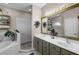 Bathroom boasts double sinks, decorative mirrors, and a separate tub and shower at 13326 Fountainbleau Dr, Clermont, FL 34711