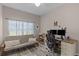 This bedroom is staged as a home office with lots of natural light and weathered plank flooring at 13326 Fountainbleau Dr, Clermont, FL 34711