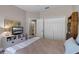 Bedroom featuring wood look floors, closet, ceiling fan, and view into an en suite bathroom at 13326 Fountainbleau Dr, Clermont, FL 34711
