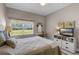 Comfortable bedroom with wood-look floors, natural light, ceiling fan, and vanity area at 13326 Fountainbleau Dr, Clermont, FL 34711