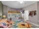 This bright bedroom features a ceiling fan, nice windows, a dresser and wood-look floors at 13326 Fountainbleau Dr, Clermont, FL 34711