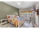 Comfortable bedroom features a decorative bed frame, ceiling fan and wood-look flooring at 13326 Fountainbleau Dr, Clermont, FL 34711