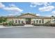 Community clubhouse featuring arched windows and a well-manicured landscape at 13326 Fountainbleau Dr, Clermont, FL 34711