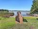 Picturesque lake view featuring a dock with a gazebo on a sunny day at 13326 Fountainbleau Dr, Clermont, FL 34711