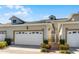 Well-maintained townhouse with a two-car garage, neat landscaping, and charming gated entrance at 13326 Fountainbleau Dr, Clermont, FL 34711