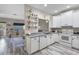 Bright kitchen features white cabinets, gray countertops and wood-look flooring at 13326 Fountainbleau Dr, Clermont, FL 34711