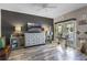 Stylish living room with wood-look flooring, neutral colors, mounted television and greenery at 13326 Fountainbleau Dr, Clermont, FL 34711