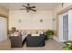Comfortable covered patio with ceiling fan, cushioned seating, and pleasant decorative touches at 13326 Fountainbleau Dr, Clermont, FL 34711