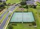 Tennis courts with lush landscaping, a playground, and other community amenities at 13326 Fountainbleau Dr, Clermont, FL 34711