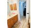 Bathroom with a single sink, wooden cabinets, and view of the entryway at 13405 Sw 86Th Ave, Ocala, FL 34473