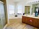 Spacious bathroom featuring a soaking tub, shower, double vanity, and ample natural light at 13405 Sw 86Th Ave, Ocala, FL 34473