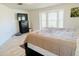 Serene bedroom featuring a comfortable bed, large windows, and neutral decor at 13405 Sw 86Th Ave, Ocala, FL 34473