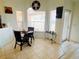 Cozy dining area nook with a round table, three chairs, and sunlit windows at 13405 Sw 86Th Ave, Ocala, FL 34473