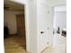 Hallway view featuring a bedroom with an armoire and another room with a desk at 13405 Sw 86Th Ave, Ocala, FL 34473