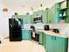 Bright kitchen featuring custom green cabinets, modern appliances, and tile backsplash at 13405 Sw 86Th Ave, Ocala, FL 34473
