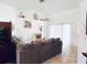Bright living room with neutral walls, wood-look flooring, and slider doors at 13405 Sw 86Th Ave, Ocala, FL 34473