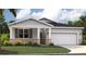 Charming one-story home featuring stone accents, gray shutters, and a well-manicured lawn at 1347 Wood Line Dr, Deland, FL 32720
