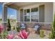 Cozy front porch featuring stone accents, decor, and two chairs perfect for outdoor relaxation at 1347 Wood Line Dr, Deland, FL 32720