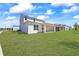Spacious backyard with a covered patio, perfect for outdoor entertaining and enjoying the serene surroundings at 15060 Brodie Ln, Winter Garden, FL 34787