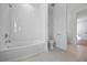 Bright bathroom featuring a shower and tub combination with white tiling and modern fixtures at 15060 Brodie Ln, Winter Garden, FL 34787