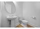 Modern powder room with a pedestal sink, sleek fixtures, and a minimalist design at 15060 Brodie Ln, Winter Garden, FL 34787