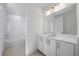 Bright bathroom with tiled floors, vanity with double doors and a shower over tub combo at 15060 Brodie Ln, Winter Garden, FL 34787