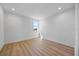 Bright bedroom with light wood floors, fresh white walls, and a window with a verdant view at 15060 Brodie Ln, Winter Garden, FL 34787