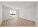Bright and airy bedroom with wood floors and a large window with neighborhood view at 15060 Brodie Ln, Winter Garden, FL 34787