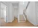 Open-concept foyer with hardwood floors and a modern staircase with metal railings at 15060 Brodie Ln, Winter Garden, FL 34787