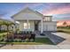 Charming two-story home featuring a covered porch, well-manicured landscaping, and a brick paver driveway at 15060 Brodie Ln, Winter Garden, FL 34787