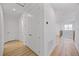Hallway with wood floors leading to an open loft area and storage closet at 15060 Brodie Ln, Winter Garden, FL 34787