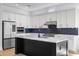 Modern kitchen featuring a large island, stainless steel appliances, and stylish backsplash at 15060 Brodie Ln, Winter Garden, FL 34787