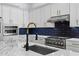 Close up on the modern kitchen featuring stainless steel appliances, stylish backsplash, and large island at 15060 Brodie Ln, Winter Garden, FL 34787