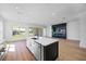 Open concept kitchen features a black and white island, stainless steel appliances and wood flooring at 15060 Brodie Ln, Winter Garden, FL 34787