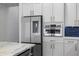Modern kitchen features white cabinets with gold hardware and stainless steel appliances at 15060 Brodie Ln, Winter Garden, FL 34787