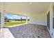 Spacious covered patio with brick flooring provides a tranquil outdoor living space at 15060 Brodie Ln, Winter Garden, FL 34787