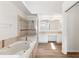 Bright bathroom with a soaking tub, glass shower, double sink vanity and wood flooring at 15746 Autumn Glen Ave, Clermont, FL 34714